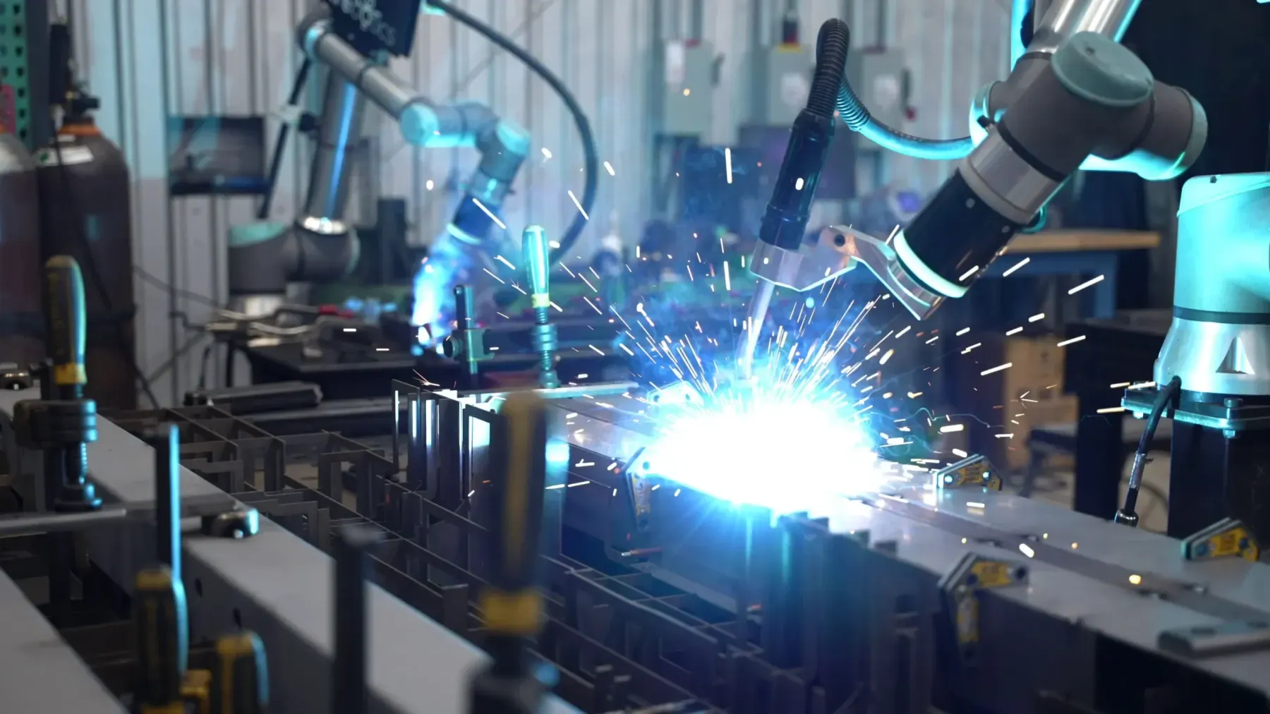 Multiple welding cobots running in a heavy fabrication shop