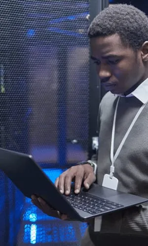 Technician in a data center aisle