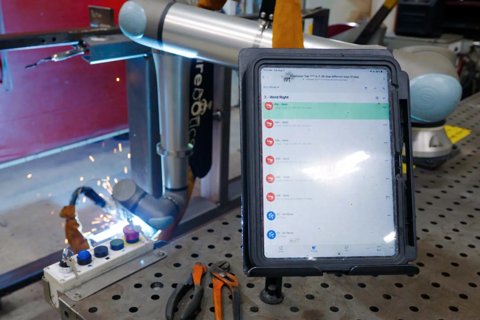 Operator running a welding cobot from the Beacon app