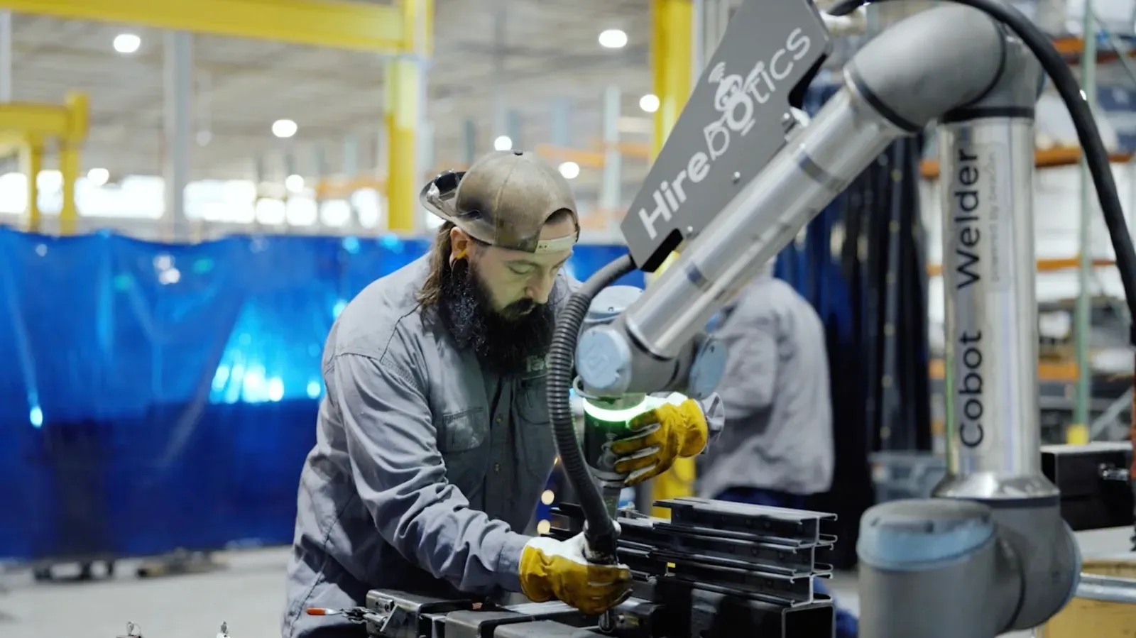 Operator hand-guiding a cobot through a weld path