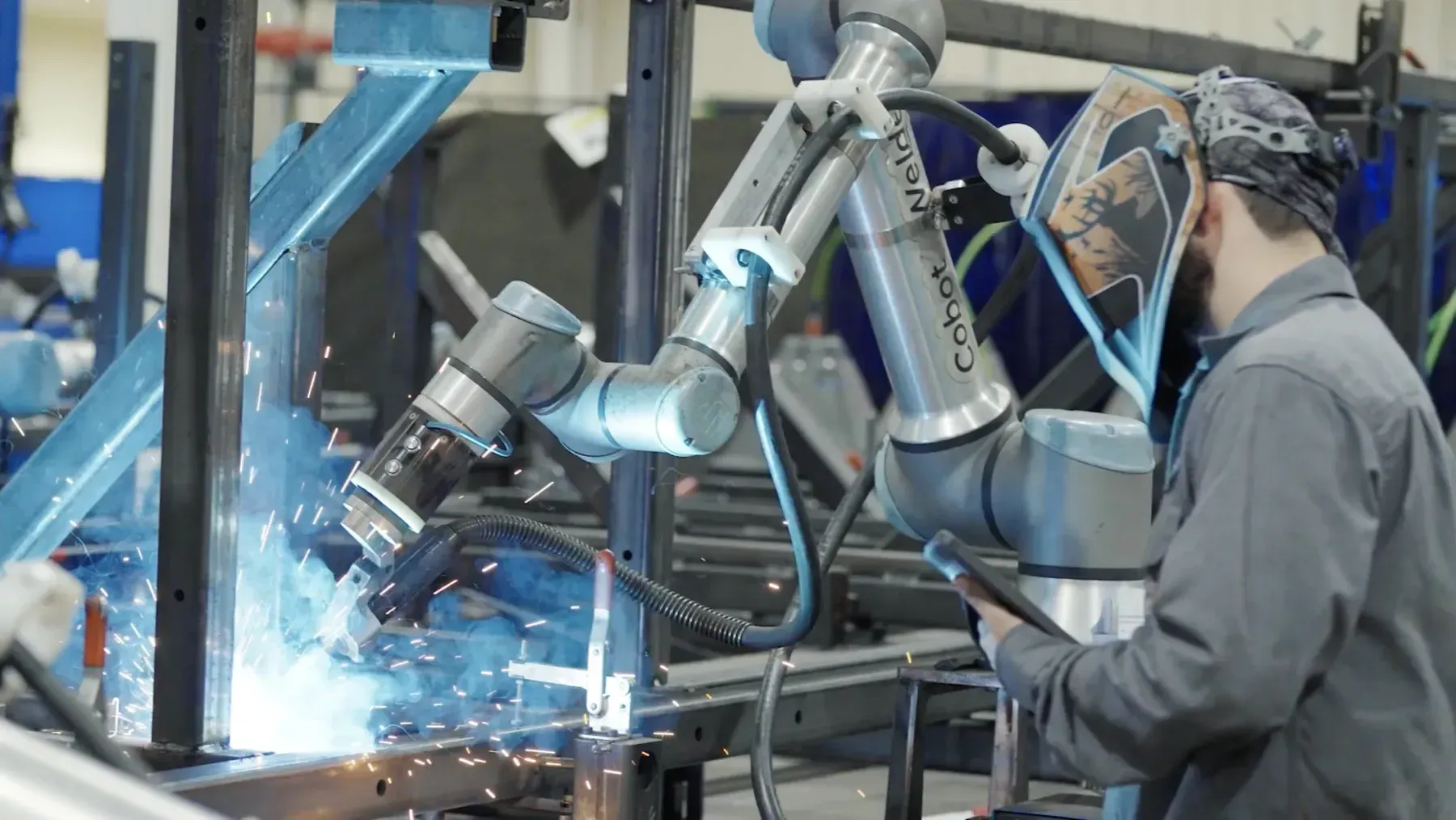 Cobot Welder running a weld with its operator alongside