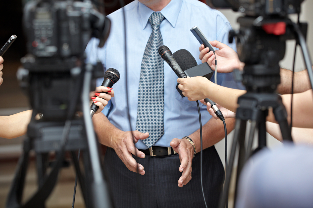 close up of conference meeting microphones and businessman