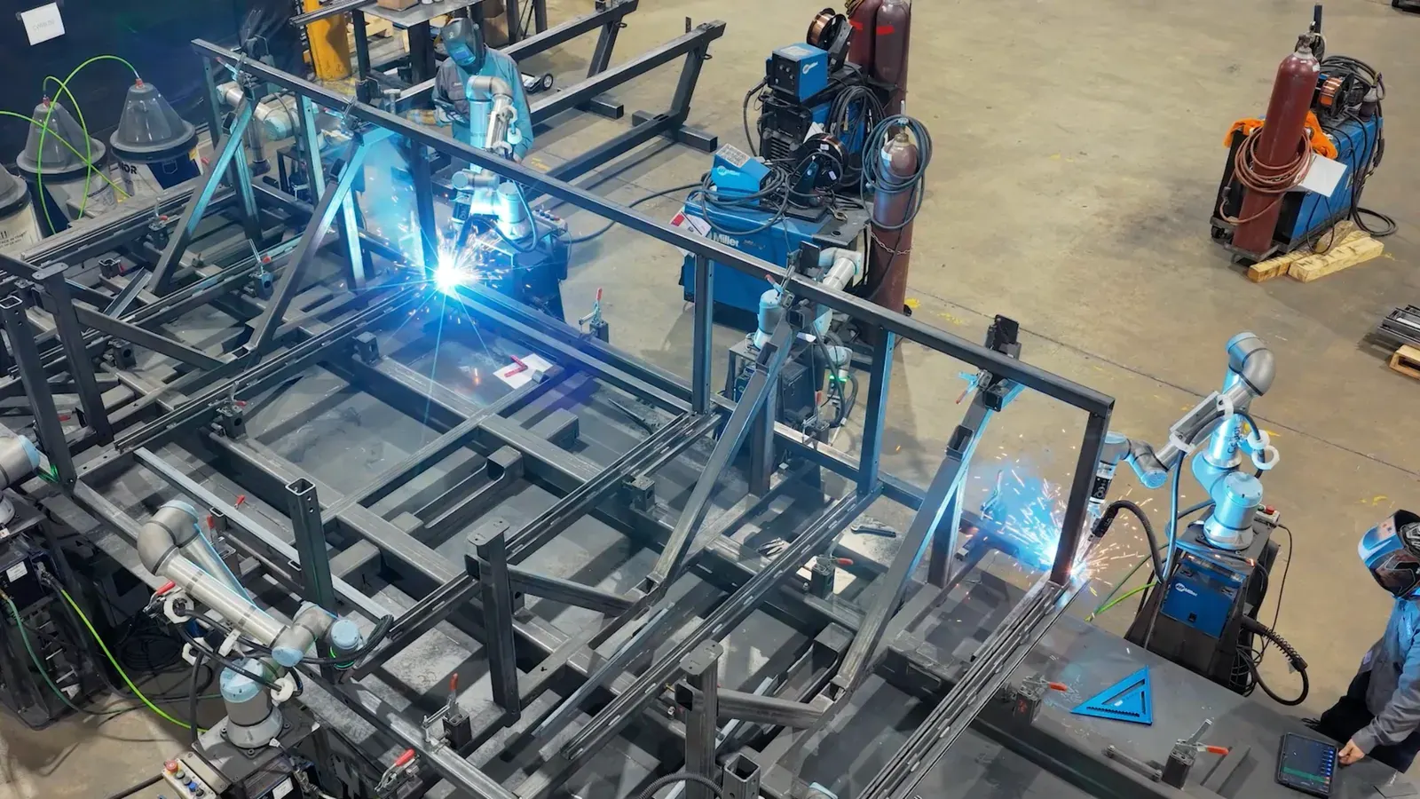 Multiple cobot welders running on a structural assembly at a Tate plant