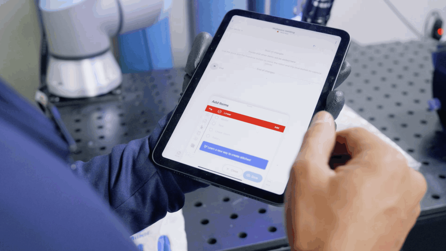 Welding operator using iPad to access Advanced Welding Controls on the Beacon app